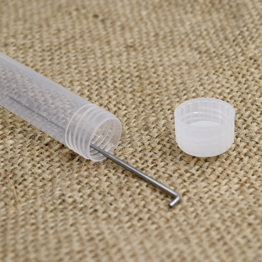 One needle felting needle in a white plastic tube on a hessian mat with a lid